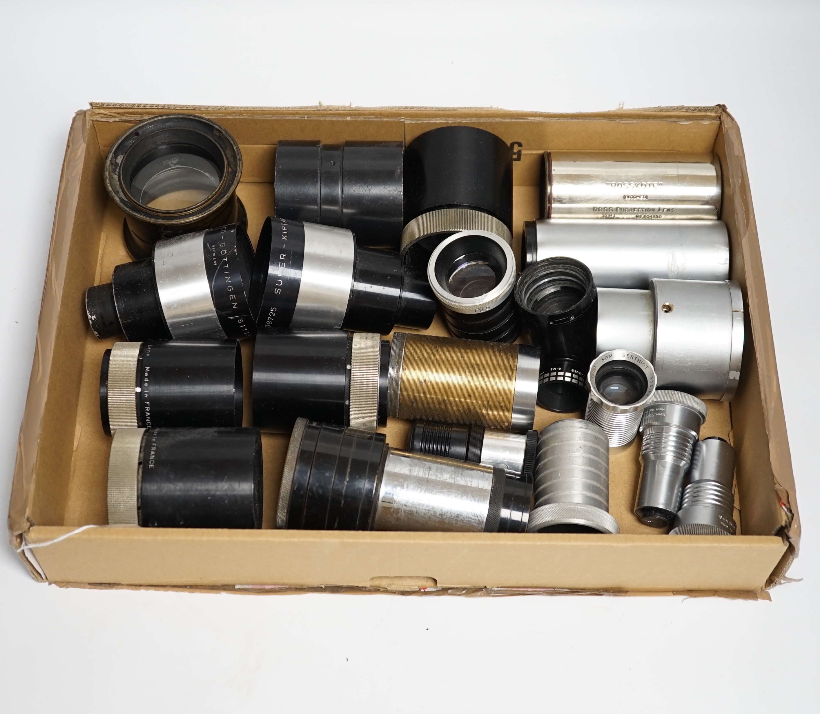 A collection of vintage cine camera lenses including examples by Taylor-Hobson, Super Six, Berthiot, Isco-Gotingen, Eumig, Ross, Gaumont Kalee, Aldis, etc.